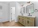 Bright bathroom featuring a double vanity with modern fixtures and wooden cabinets, providing ample storage space at 6895 Smoke Ridge Dr, Atlanta, GA 30349