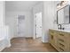 Main bathroom features wood-look floors, stylish vanity and tub at 6895 Smoke Ridge Dr, Atlanta, GA 30349