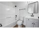 Bathroom features a sleek black framed mirror above a gray vanity and modern fixtures in front of a shower-tub at 6895 Smoke Ridge Dr, Atlanta, GA 30349