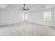Large main bedroom with tray ceiling, ceiling fan, and large windows at 6895 Smoke Ridge Dr, Atlanta, GA 30349