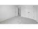 A bright bedroom with a walk-in closet and doorway provides a view into another room at 6895 Smoke Ridge Dr, Atlanta, GA 30349