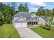 Charming two-story home with a manicured lawn, inviting front porch, and a two-car garage at 6895 Smoke Ridge Dr, Atlanta, GA 30349