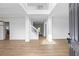 Bright foyer with hardwood floors, white trim, and a staircase leading to the upper level at 6895 Smoke Ridge Dr, Atlanta, GA 30349