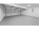 Spacious two-car garage with a sealed concrete floor and white doors providing secure parking and storage at 6895 Smoke Ridge Dr, Atlanta, GA 30349