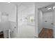 Upstairs hallway with laundry closet and view of staircase and landing at 6895 Smoke Ridge Dr, Atlanta, GA 30349