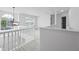 Hallway features abundant natural light, white railing and a stylish pendant light at 6895 Smoke Ridge Dr, Atlanta, GA 30349