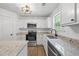 Well-equipped kitchen featuring stainless appliances, granite countertops, and modern lighting at 6895 Smoke Ridge Dr, Atlanta, GA 30349