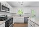 Well-equipped kitchen featuring stainless steel appliances, granite counters, and ample storage at 6895 Smoke Ridge Dr, Atlanta, GA 30349