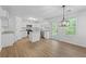 Well-lit kitchen with white cabinets, granite countertops, stainless steel appliances, and a dining area at 6895 Smoke Ridge Dr, Atlanta, GA 30349