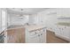 Bright kitchen with granite island and stainless appliances open to the living space at 6895 Smoke Ridge Dr, Atlanta, GA 30349