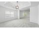 Bright, open-concept living room with windows and carpet flooring at 6895 Smoke Ridge Dr, Atlanta, GA 30349