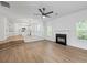 Open concept living space features a fireplace, kitchen, and ample natural light at 6895 Smoke Ridge Dr, Atlanta, GA 30349