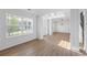 Open-concept living room with hardwood floors, large windows, and elegant trim, creating a bright and inviting space at 6895 Smoke Ridge Dr, Atlanta, GA 30349