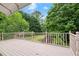 An outdoor deck with railings overlooks the lush greenery of the backyard at 1000 Grimes Bridge Rd, Roswell, GA 30075