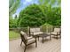 Back deck with outdoor furniture overlooking lush green backyard with wooded area at 1000 Grimes Bridge Rd, Roswell, GA 30075
