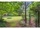 Lush backyard featuring an arched metal gate and pathways throughout at 1000 Grimes Bridge Rd, Roswell, GA 30075