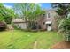 Well-maintained backyard with a deck, lush greenery, and a stepping stone path at 1000 Grimes Bridge Rd, Roswell, GA 30075