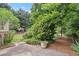 A spacious backyard with mature trees, lush plantings, and a charming gazebo at 1000 Grimes Bridge Rd, Roswell, GA 30075
