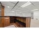 Finished basement bar area with dark countertop, wooden paneling, and built-in shelving at 1000 Grimes Bridge Rd, Roswell, GA 30075