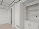 Finished basement showcasing built-in shelving and door to an additional room at 1000 Grimes Bridge Rd, Roswell, GA 30075