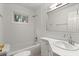Clean white bathroom featuring a tub-shower combination, white subway tile, and a marble-style vanity at 1000 Grimes Bridge Rd, Roswell, GA 30075