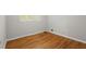 Bedroom featuring hardwood floors and natural light from shuttered windows at 1000 Grimes Bridge Rd, Roswell, GA 30075