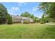 Charming single-story home with a well-manicured lawn and manicured landscaping at 1000 Grimes Bridge Rd, Roswell, GA 30075