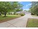 Traditional home featuring a long driveway and attached garage; beautifully landscaped front yard with mature trees at 1000 Grimes Bridge Rd, Roswell, GA 30075
