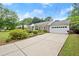 Brick home with a well-kept lawn, mature landscaping, concrete driveway and an attached two-car garage at 1000 Grimes Bridge Rd, Roswell, GA 30075