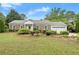 Charming brick ranch-style home with a well-manicured lawn, mature trees, and a two-car garage at 1000 Grimes Bridge Rd, Roswell, GA 30075