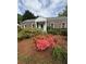 Charming one-story brick home with mature landscaping featuring flowering shrubs at 1000 Grimes Bridge Rd, Roswell, GA 30075