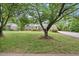 Charming single story home with a well-manicured front lawn and mature trees at 1000 Grimes Bridge Rd, Roswell, GA 30075