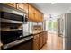 Kitchen featuring modern appliances, granite countertops, and convenient access to the dining area at 1000 Grimes Bridge Rd, Roswell, GA 30075