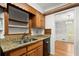 Charming kitchen with granite counters, custom cabinetry and dining room access at 1000 Grimes Bridge Rd, Roswell, GA 30075