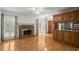 Cozy living room with fireplace, hardwood floors, and custom cabinets in an open-concept design at 1000 Grimes Bridge Rd, Roswell, GA 30075