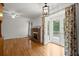 Spacious living room with hardwood floors, brick fireplace, and access to the outdoor patio at 1000 Grimes Bridge Rd, Roswell, GA 30075