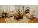 Cozy living room with neutral decor, hardwood flooring, plantation shutters, and a comfortable seating area at 1000 Grimes Bridge Rd, Roswell, GA 30075