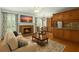 Bright living room with fireplace, TV, hardwood floors, and dining area adjacent to the kitchen at 1000 Grimes Bridge Rd, Roswell, GA 30075