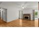 Inviting living room with a brick fireplace, hardwood floors, and light-filled windows at 1000 Grimes Bridge Rd, Roswell, GA 30075