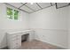Office with built-in desk, paneled walls and neutral carpet at 1000 Grimes Bridge Rd, Roswell, GA 30075