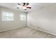 Bedroom with neutral walls and carpet, a ceiling fan, and natural light from two windows at 15 Ashton Pl, Covington, GA 30016