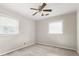Bedroom with neutral walls and carpet, a ceiling fan, and natural light from two windows at 15 Ashton Pl, Covington, GA 30016