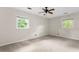 Bedroom with neutral walls and carpet, a ceiling fan, and natural light from two windows at 15 Ashton Pl, Covington, GA 30016
