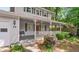 Close-up of the covered front porch and entrance with white railings and an inviting red front door at 15 Ashton Pl, Covington, GA 30016