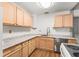Bright kitchen features light wood cabinets, granite countertops, and modern appliances for a functional cooking space at 15 Ashton Pl, Covington, GA 30016