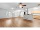 Large living room with hardwood floors and brick accents, blending space and warmth for comfortable living at 15 Ashton Pl, Covington, GA 30016