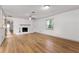 Bright living room with hardwood floors and fireplace, complemented by neutral paint, offering a cozy atmosphere at 15 Ashton Pl, Covington, GA 30016