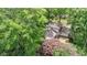 An aerial view showing the home's rear exterior with a chimney, surrounded by lush trees at 15 Ashton Pl, Covington, GA 30016
