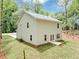 Aerial view of house with cream siding situated in a yard with newly laid sod and bordered by mature trees at 191 Davis Ct, Hiram, GA 30141