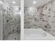 This bathroom has a tiled shower and tub combination with white fixtures at 191 Davis Ct, Hiram, GA 30141